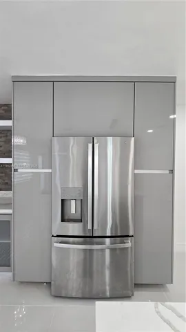 a kitchen with a refrigerator and microwave