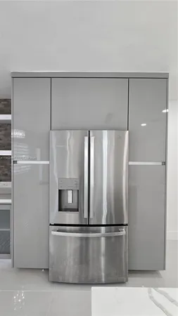 a kitchen with a refrigerator and microwave