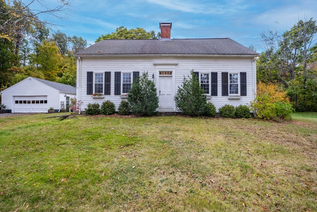 a front view of house with yard and green space