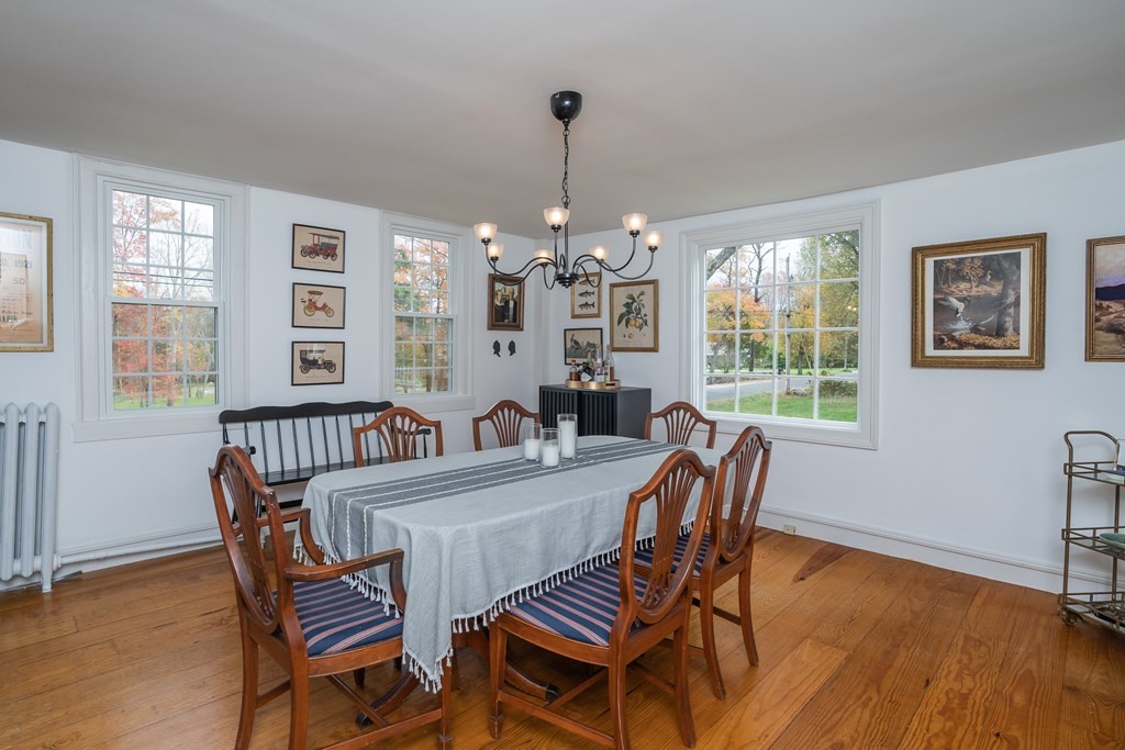 324 Chapin Road Hampden, MA 01036 - Photo 17 of 42 a dining room with furniture a chandelier and wooden floor