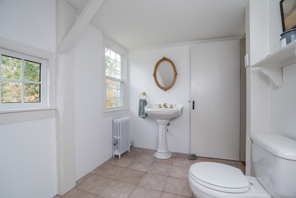 324 Chapin Road Hampden, MA 01036 - Photo 40 of 42 a bathroom with a toilet sink and mirror