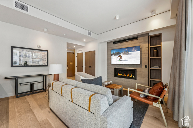 2417 West High Mountain Road, Unit 2202 Park City, UT 84098 - Photo 5 of 28 Living room featuring a tile fireplace, light hardwood / wood-style flooring, and built in features