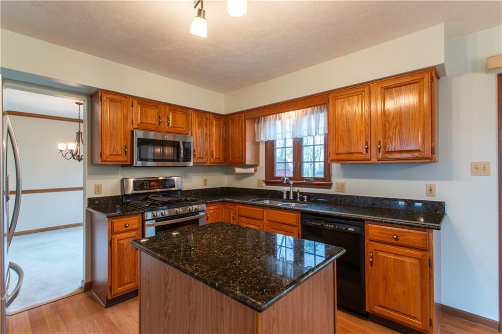128 Moffett Run Road Aliquippa, PA 15001 - Photo 15 of 48 a kitchen with stainless steel appliances granite countertop a sink stove and microwave
