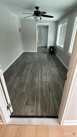 a view of a room with wooden floor