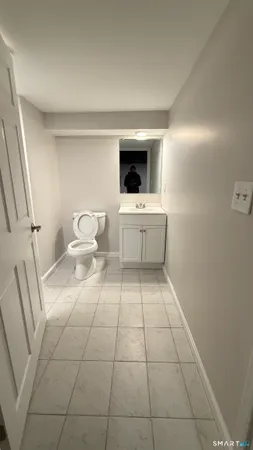 a room with a washing machine and cabinets