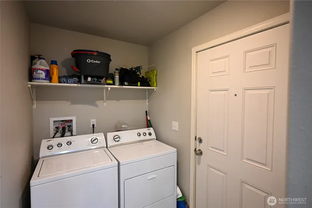 a view of storage and utility room with washer and dryer