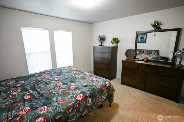 a bedroom with a bed and a dresser