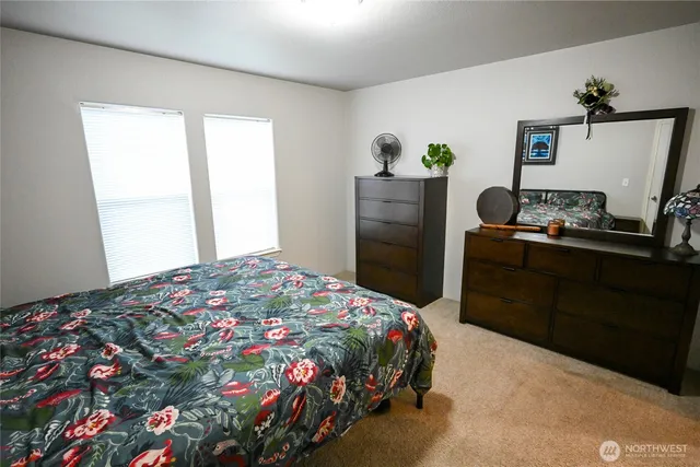 a bedroom with a bed and a dresser