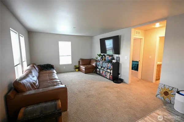 a living room with furniture and large windows