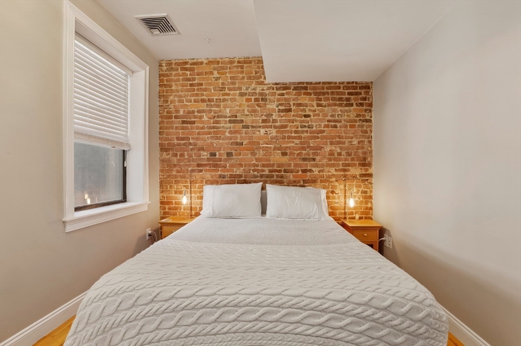 454 Hanover Street, Unit 4 Boston, MA 02113 - Photo 15 of 23 a bedroom with a bed and a window