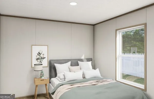 a bedroom with a bed and a painting on the wall