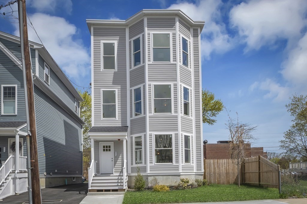 68 Edson Street, Unit 1 Boston, MA 02124 - Photo 1 of 23 a front view of a house with a yard