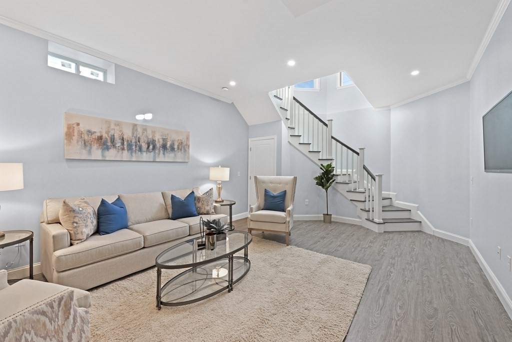 68 Edson Street, Unit 1 Boston, MA 02124 - Photo 14 of 23 a living room with furniture and a chandelier