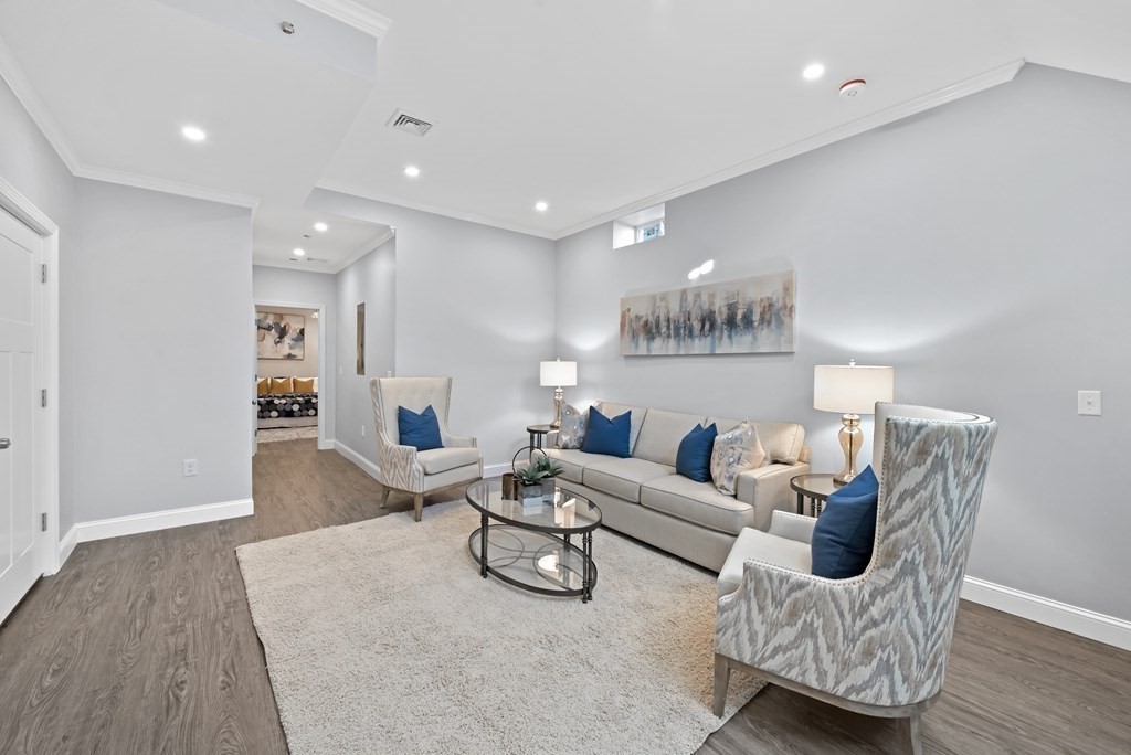 68 Edson Street, Unit 1 Boston, MA 02124 - Photo 15 of 23 a living room with furniture and a wooden floor