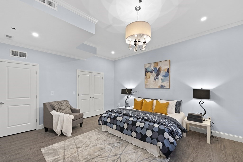 68 Edson Street, Unit 1 Boston, MA 02124 - Photo 16 of 23 a bedroom with bed and a couch