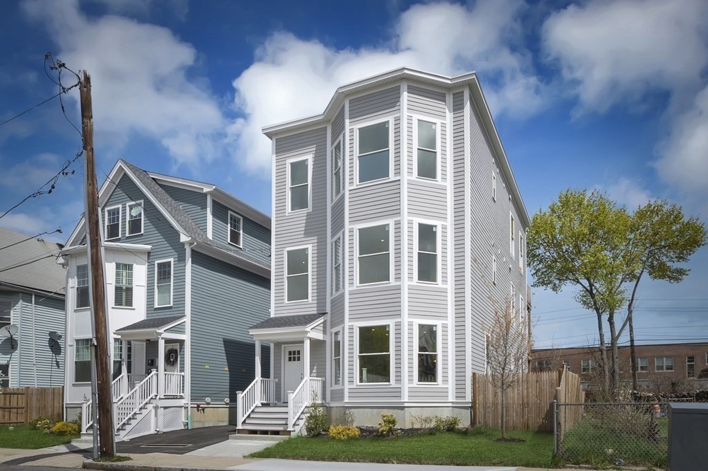 68 Edson Street, Unit 1 Boston, MA 02124 - Photo 2 of 23 a front view of a house with a yard