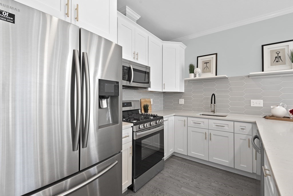 68 Edson Street, Unit 1 Boston, MA 02124 - Photo 6 of 23 a kitchen with stainless steel appliances a refrigerator sink and microwave