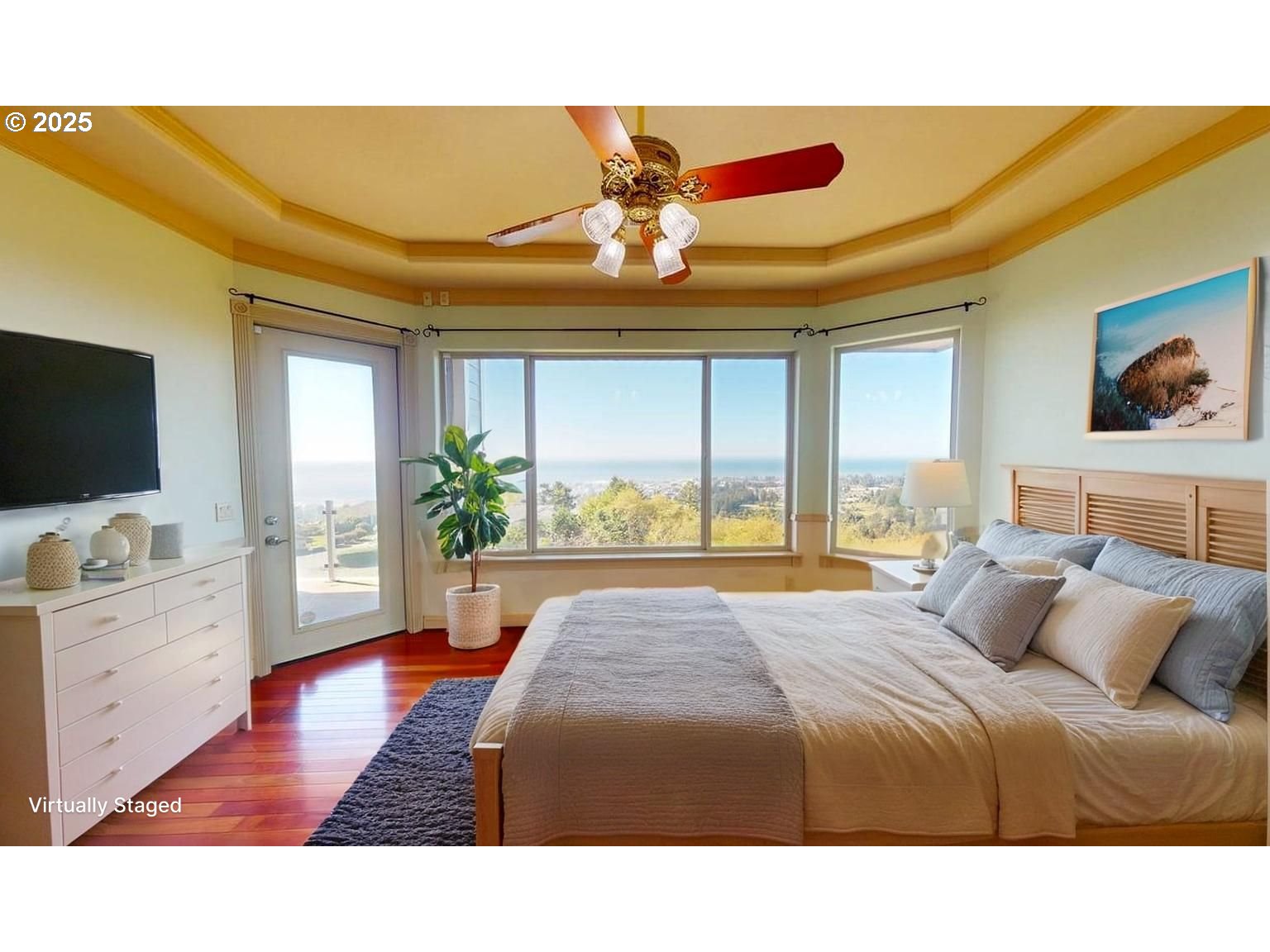 16898 Crown Terrace Brookings, OR 97415 - Photo 14 of 42 a bedroom with a large bed and a flat screen tv