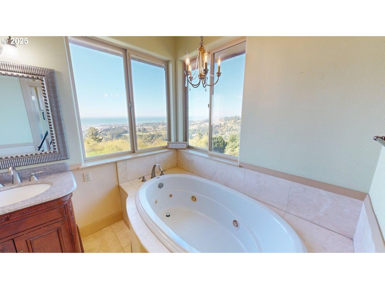 16898 Crown Terrace Brookings, OR 97415 - Photo 17 of 42 a bathroom with a sink mirror and a bathtub