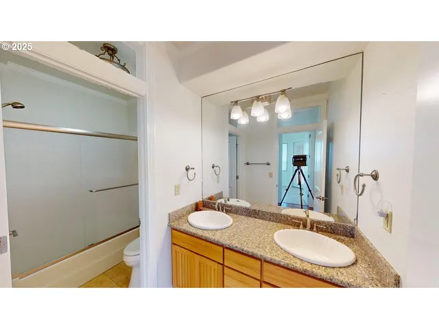 a bathroom with a sink double vanity and a mirror