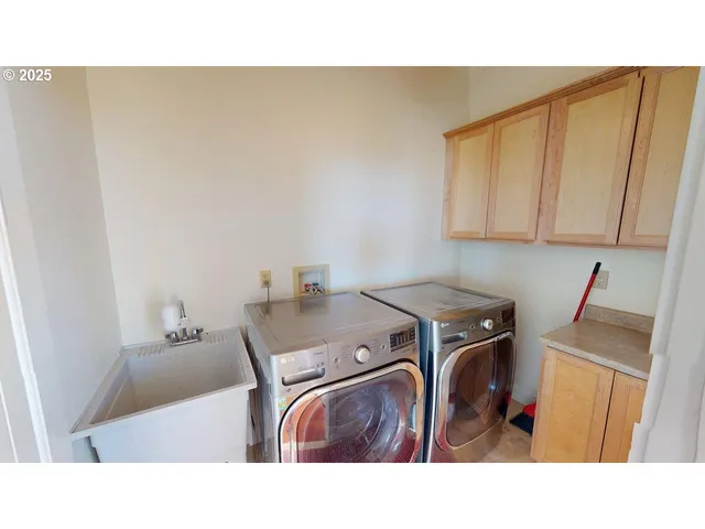 a kitchen with a sink a stove and cabinets
