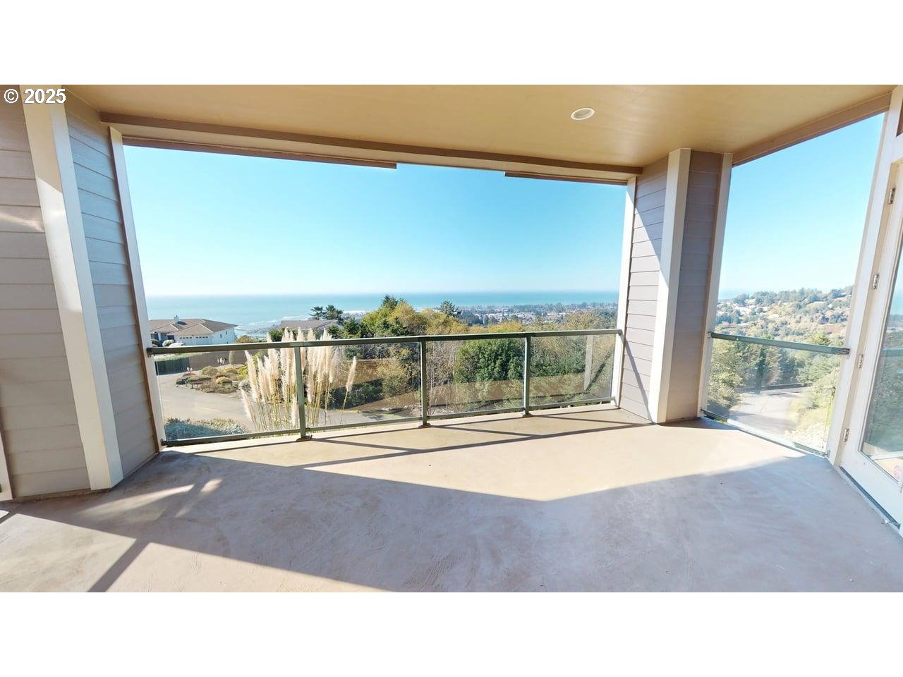 16898 Crown Terrace Brookings, OR 97415 - Photo 32 of 42 a room with a floor to ceiling window and an outdoor view