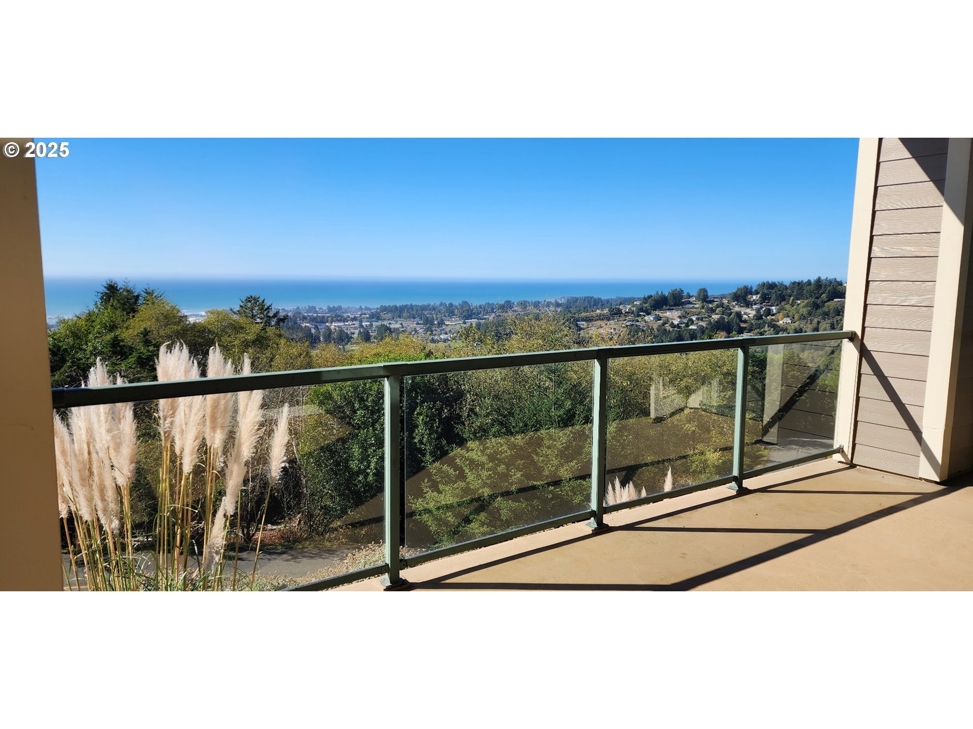 16898 Crown Terrace Brookings, OR 97415 - Photo 33 of 42 a view of a balcony with a floor to ceiling window and wooden floor