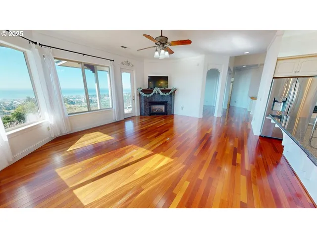 a living room with wooden floors and a dining table