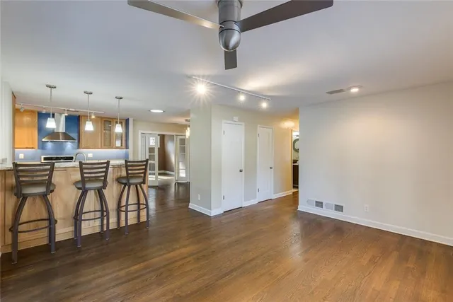 a view of a kitchen with furniture and wooden floor