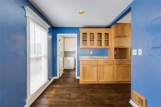 a view of a kitchen with wooden floor and more cabinets
