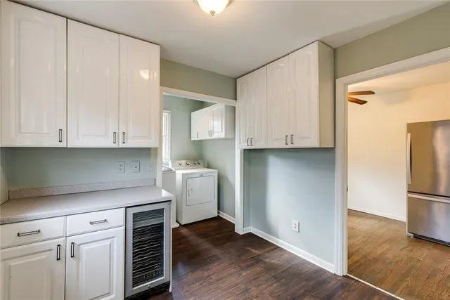 a kitchen with a refrigerator and cabinets