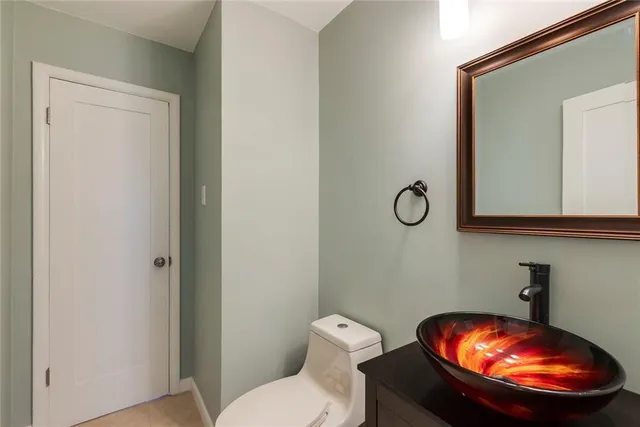 a bathroom with a toilet and a mirror