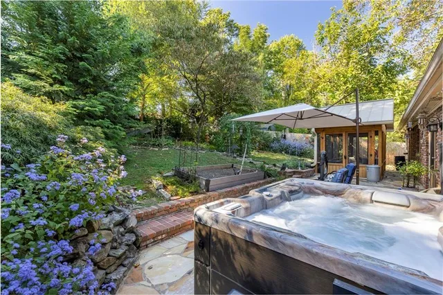 a view of a patio with table and chairs under an umbrella