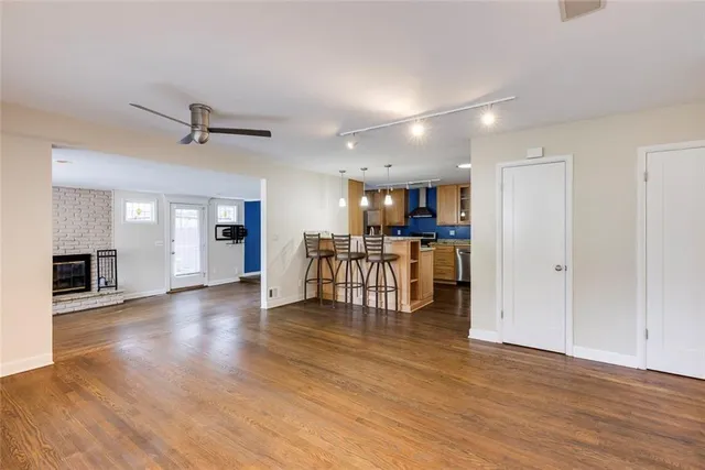 a view of a kitchen with a sink and a refrigerator