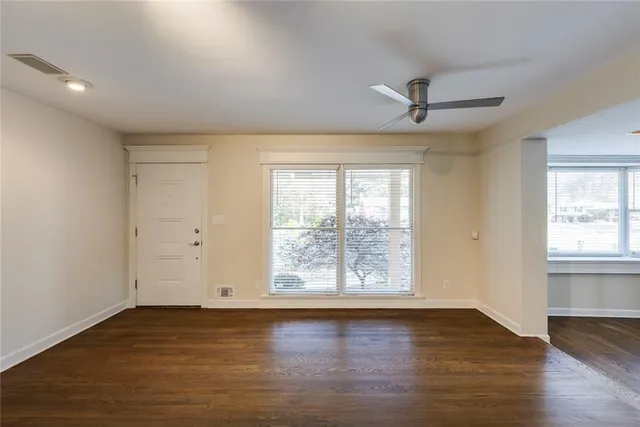 wooden floor in an empty room with a window