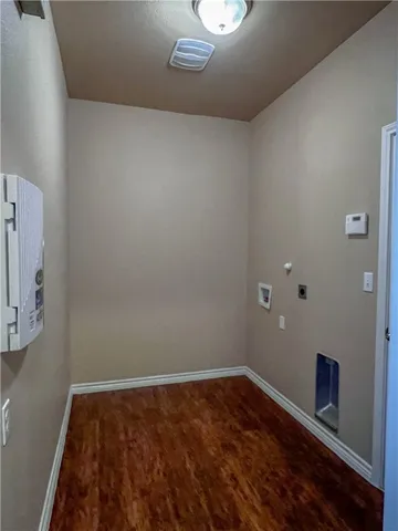 a view of room with wooden floor and fan