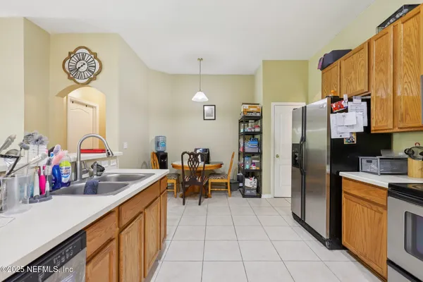 a kitchen with stainless steel appliances granite countertop a refrigerator and a sink