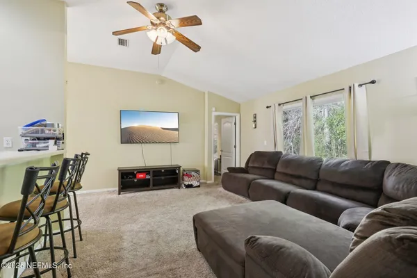 a living room with furniture a couch and a window