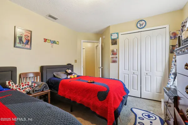 a bedroom with a bed and a couch