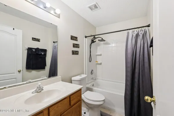 a bathroom with a sink toilet double vanity and shower