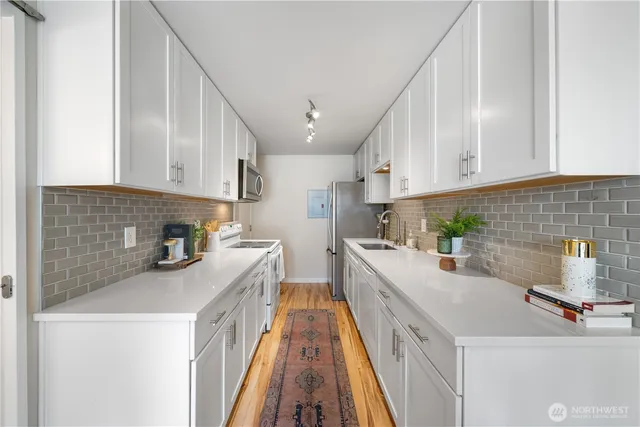a kitchen with a sink a stove and cabinets