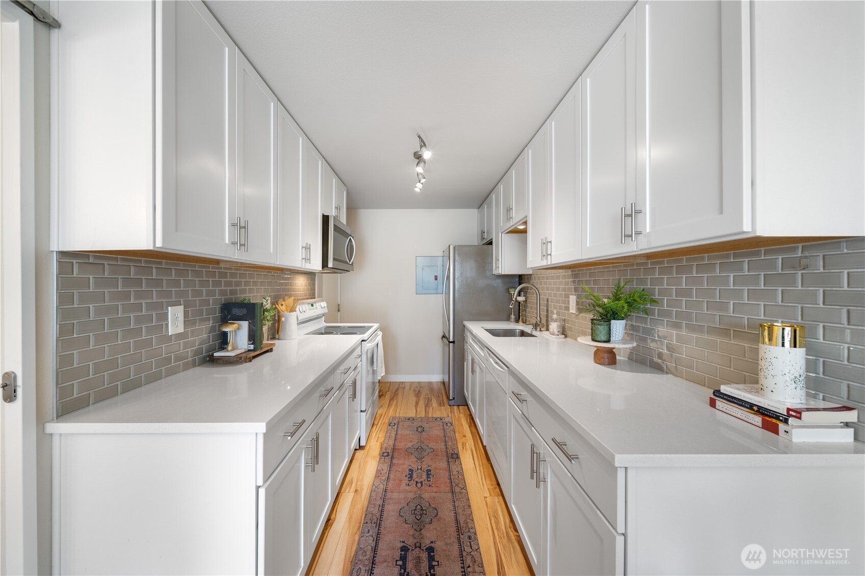 1529 201st Place Southeast, Unit 12C Bothell, WA 98012 - Photo 11 of 27 a kitchen with a sink a stove and cabinets