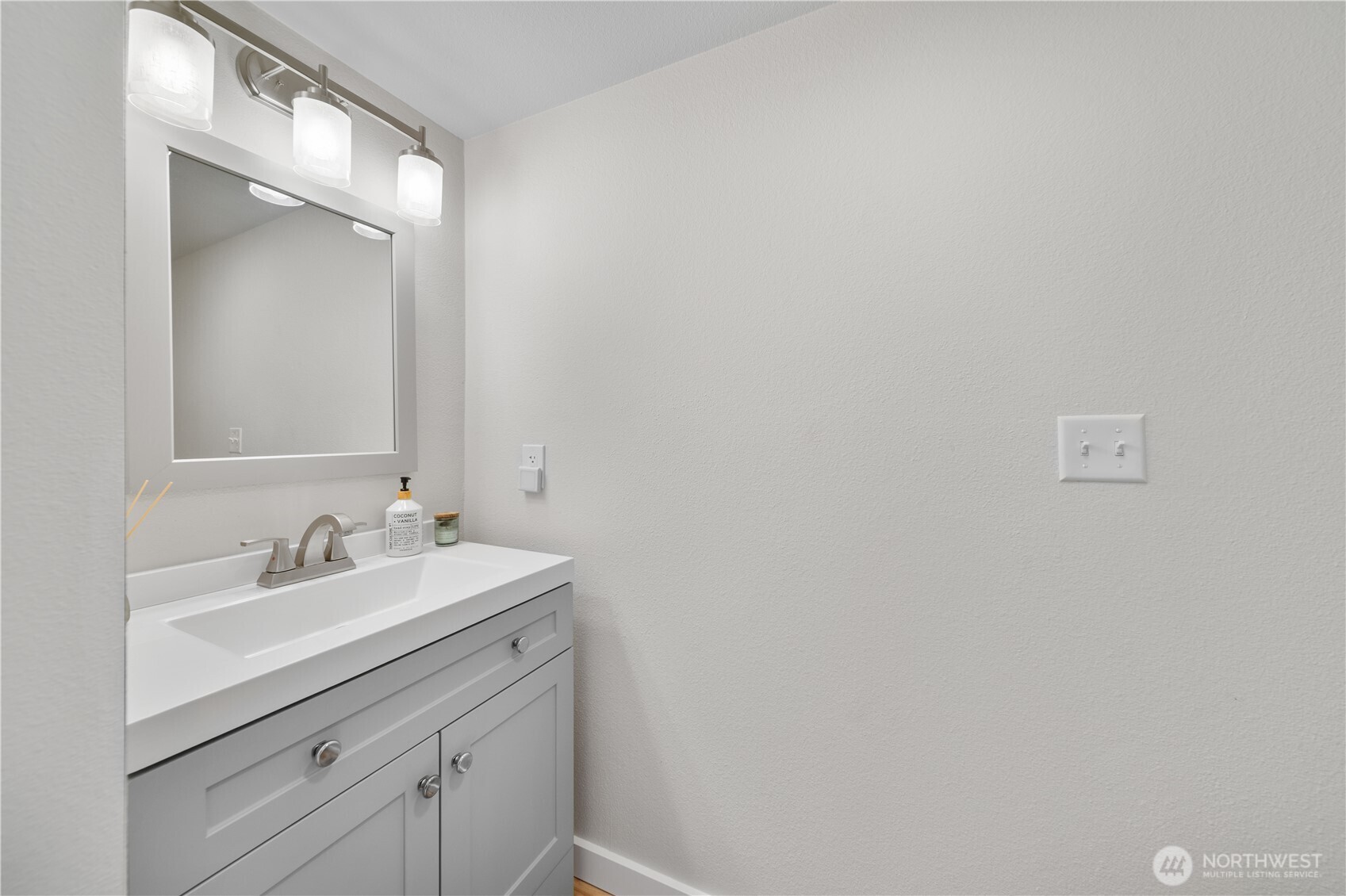 1529 201st Place Southeast, Unit 12C Bothell, WA 98012 - Photo 12 of 27 a bathroom with a sink and a mirror