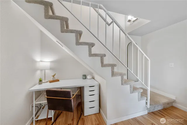 a view of entryway and hall with wooden floor
