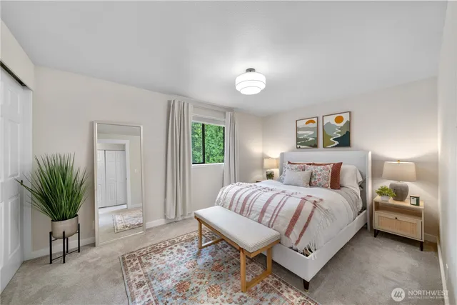 a bedroom with a bed and a potted plant