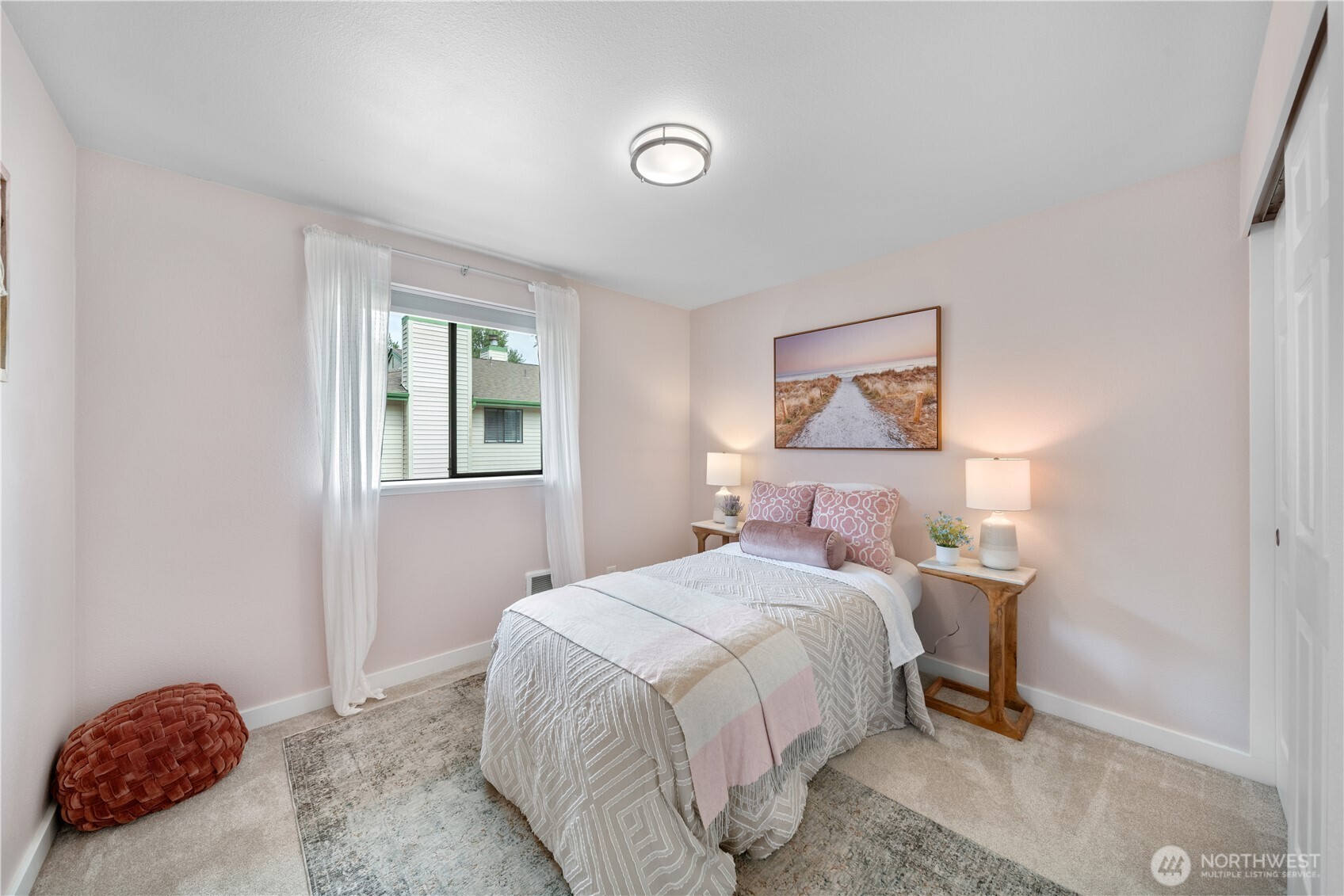 1529 201st Place Southeast, Unit 12C Bothell, WA 98012 - Photo 17 of 27 a bedroom with a bed and a lamp on the dresser