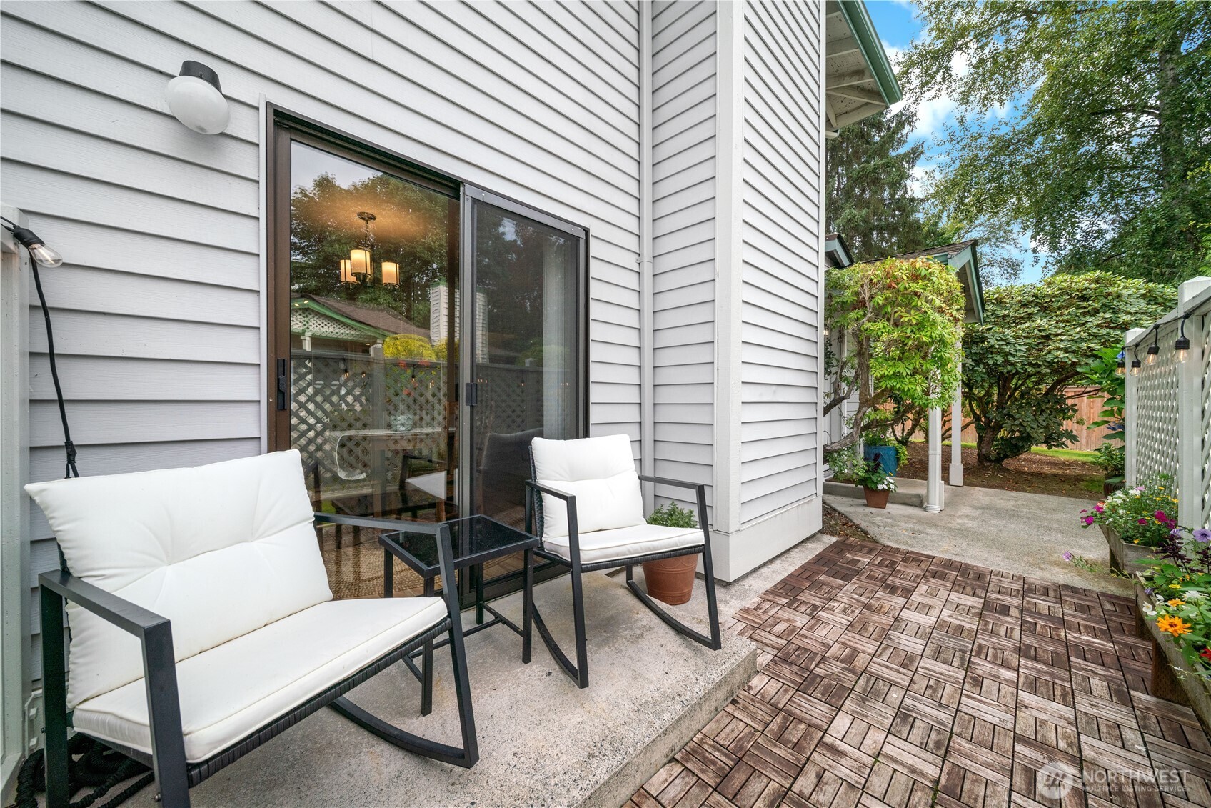 1529 201st Place Southeast, Unit 12C Bothell, WA 98012 - Photo 21 of 27 a view of a patio with a table and chairs and potted plants