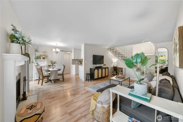 a living room with furniture fireplace and a potted plant