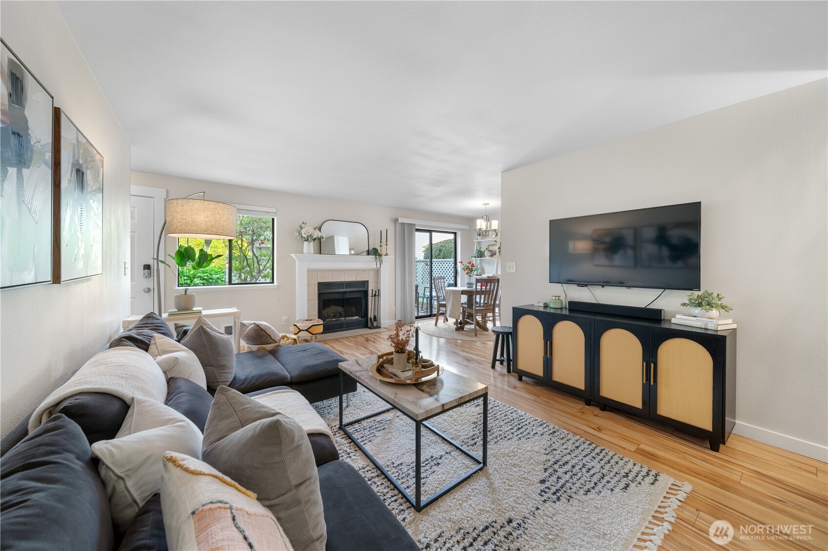1529 201st Place Southeast, Unit 12C Bothell, WA 98012 - Photo 5 of 27 a living room with furniture a flat screen tv and a fireplace
