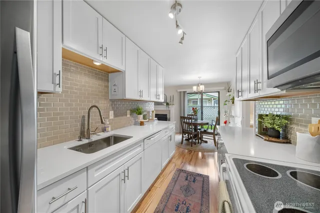 a kitchen with sink a counter space and appliances